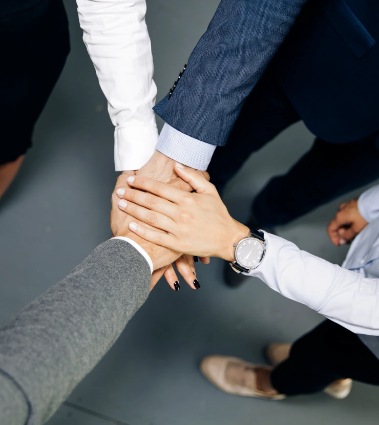 Colleagues joining hands
